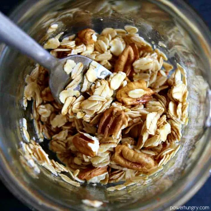 uncooked ingredients for micrwave granola in a glass mug