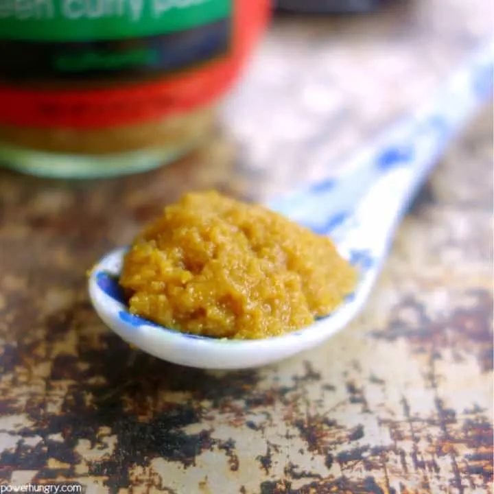 close-up of Thai green curry paste on a blue and whit porcelain spoon