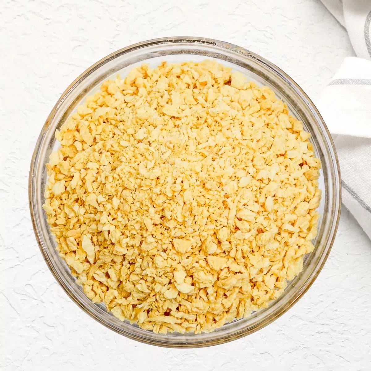 bowl of dry tvp on a white background