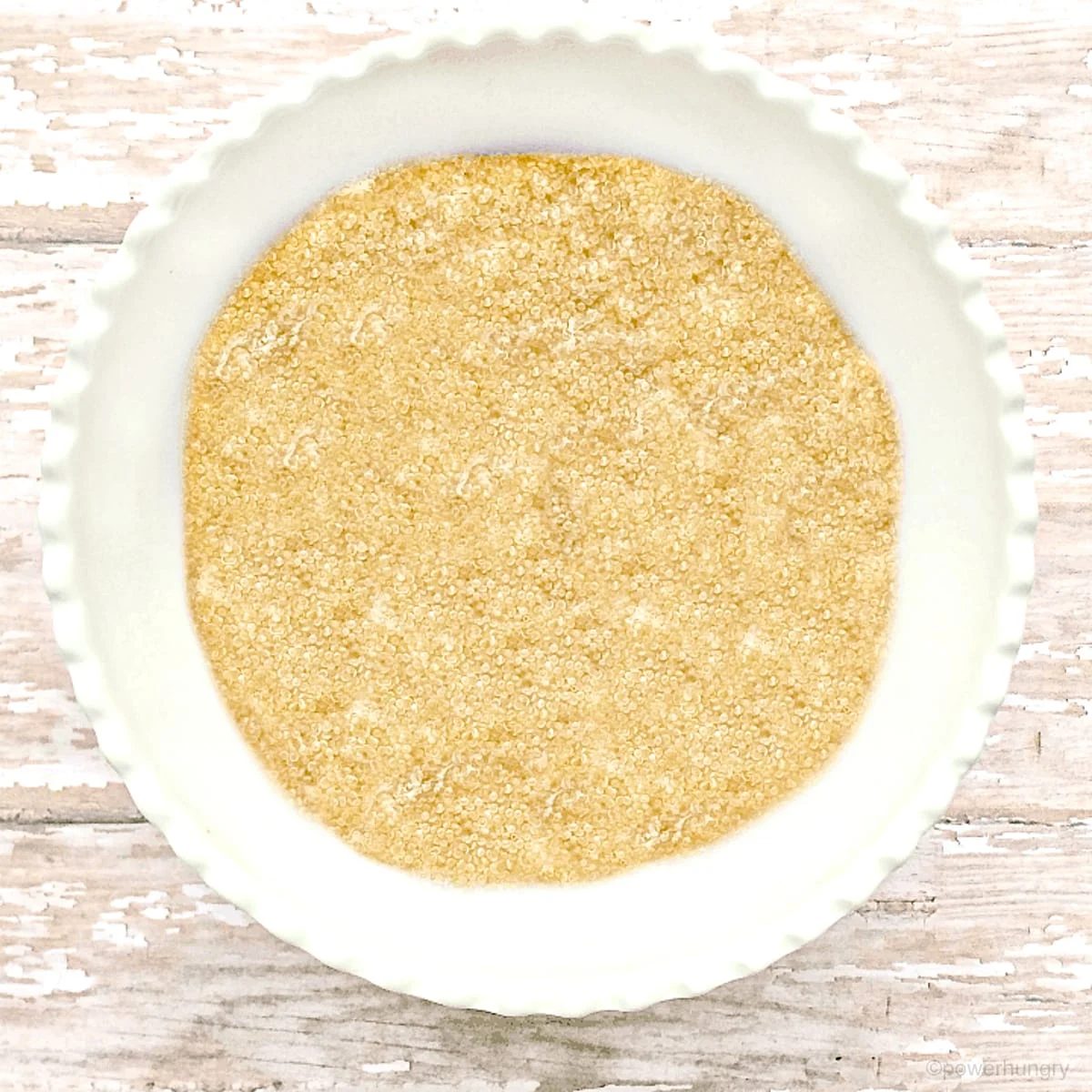 white bowl with amaranth porridge on a wood surface