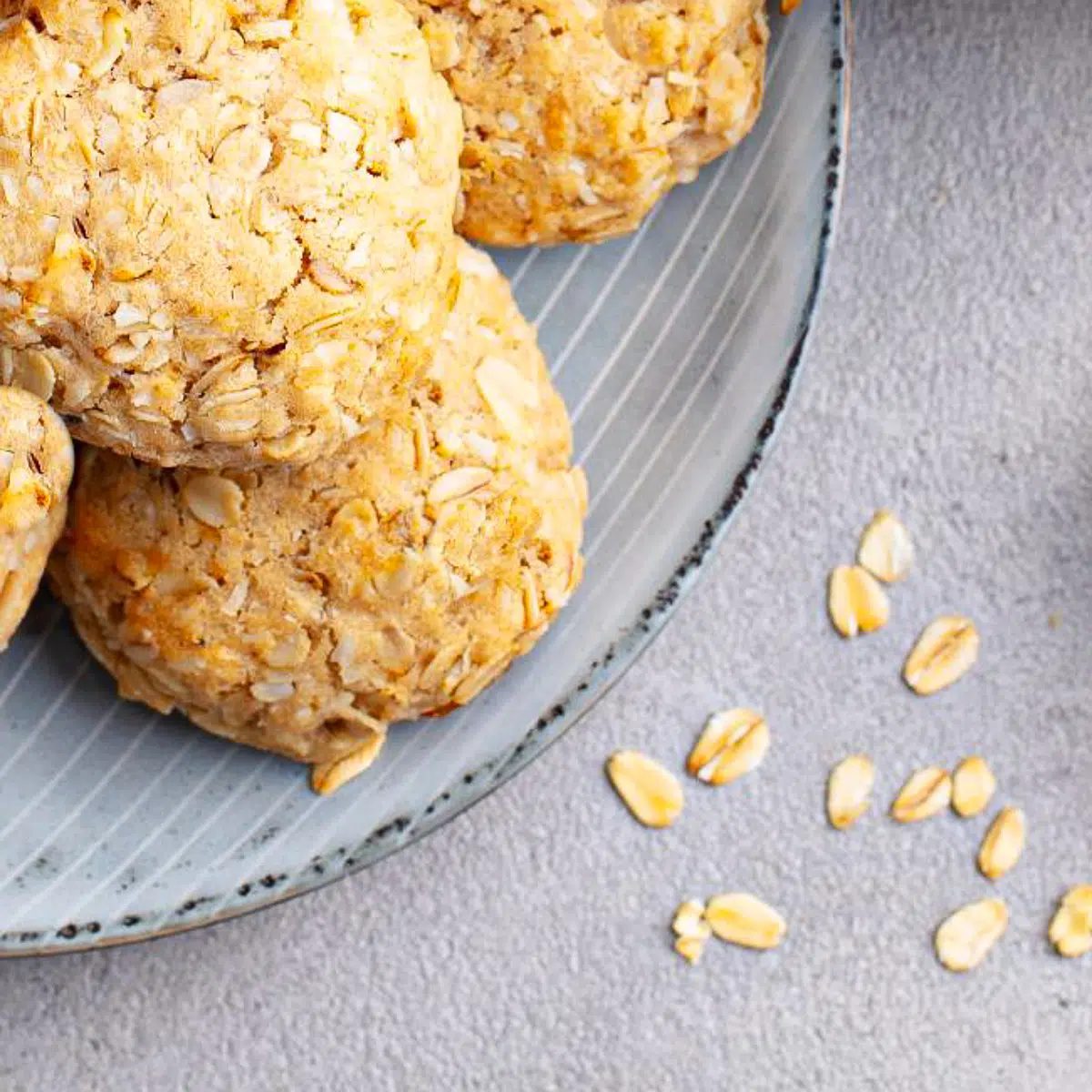 almond oat flour cookies on a plate with oats alongside