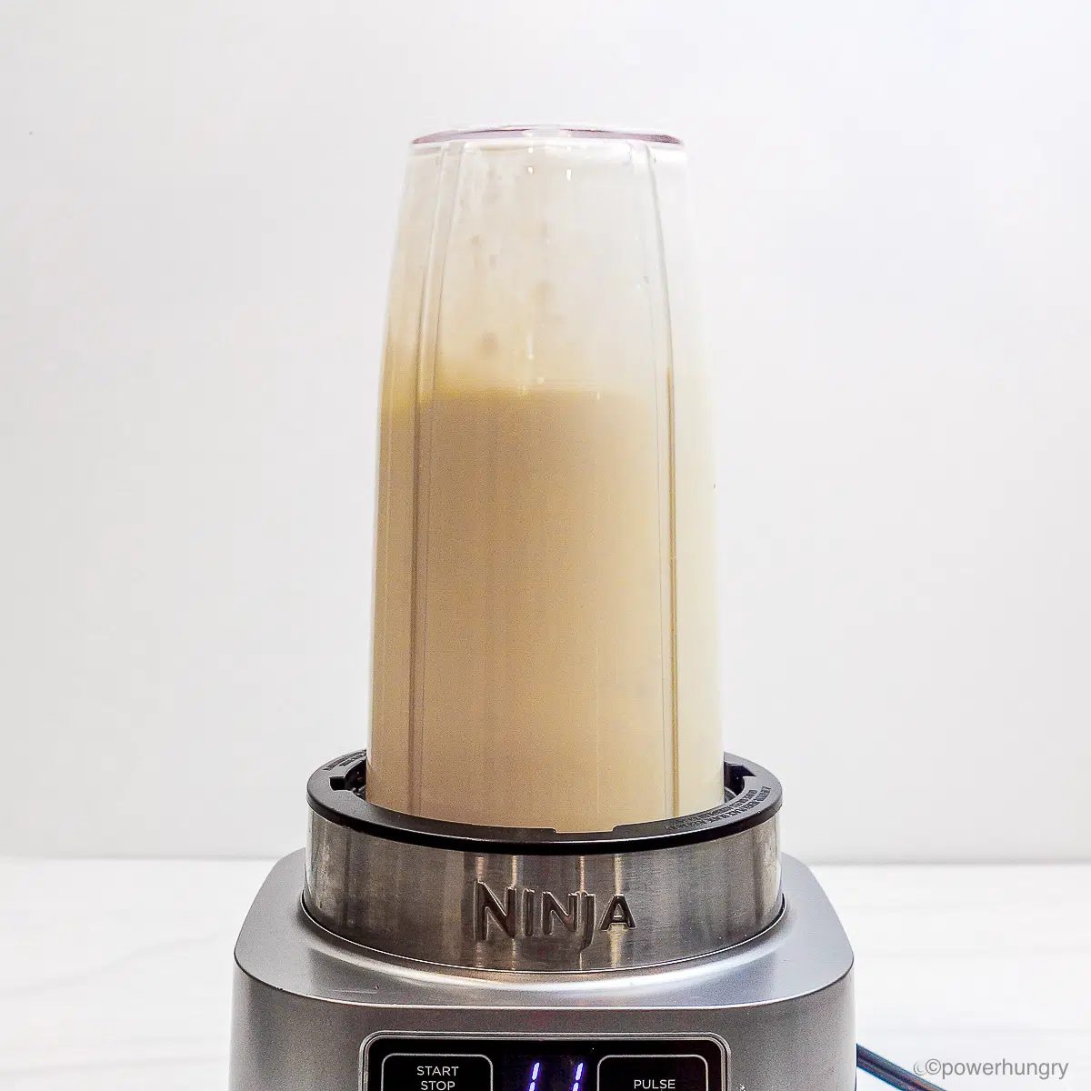 bullet blender filled with wet ingredients for cookies, blended