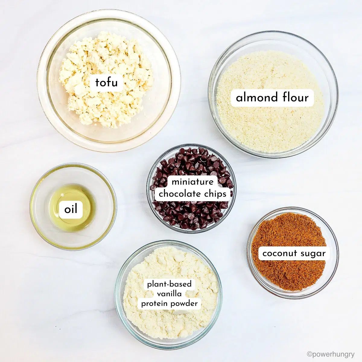 glass bowls filled with the ingredients for almond flour protein cookies