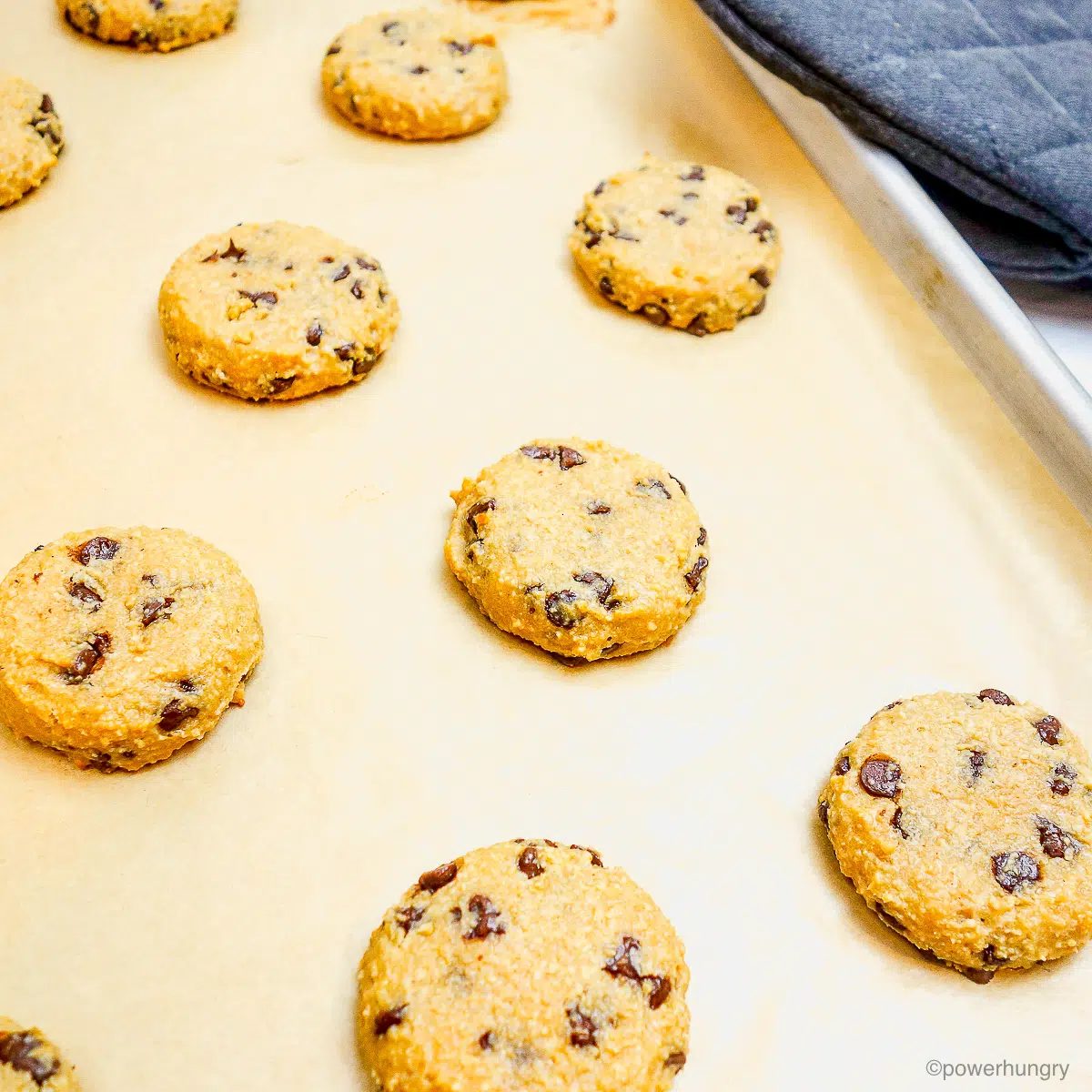 protein cookies baked on a parchmet paper lined baking sheet