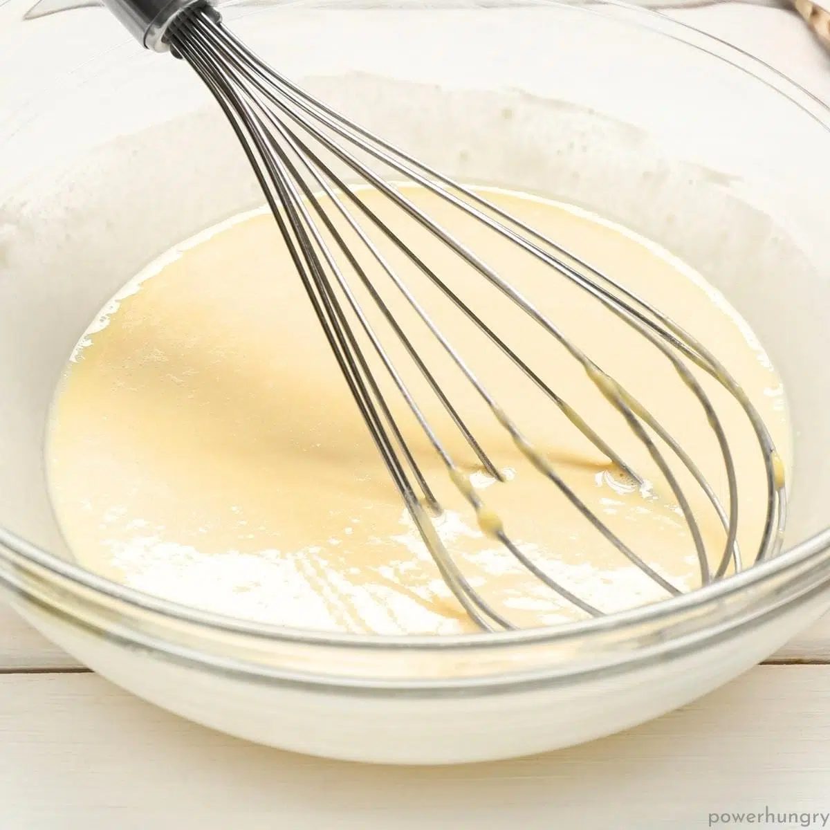 glass bowl and whisk with amaranth tortilla batter