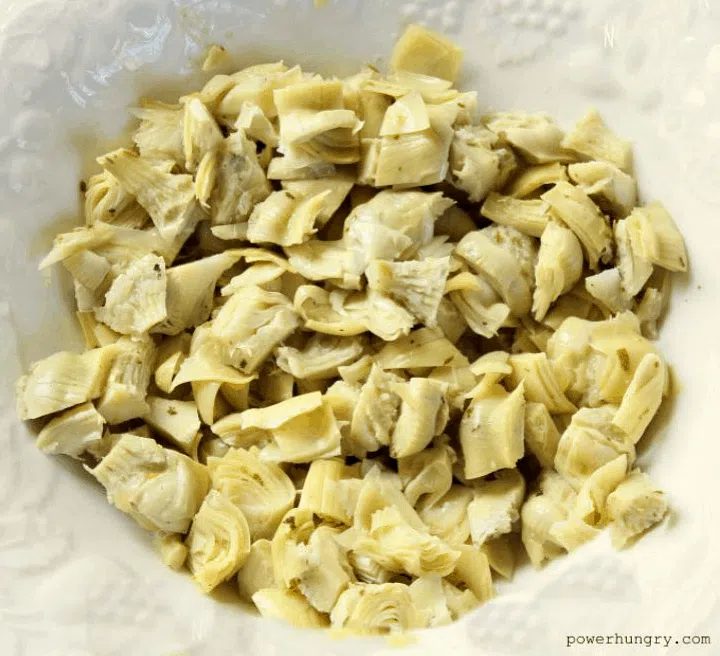 white bowl with artichoke hearts inside
