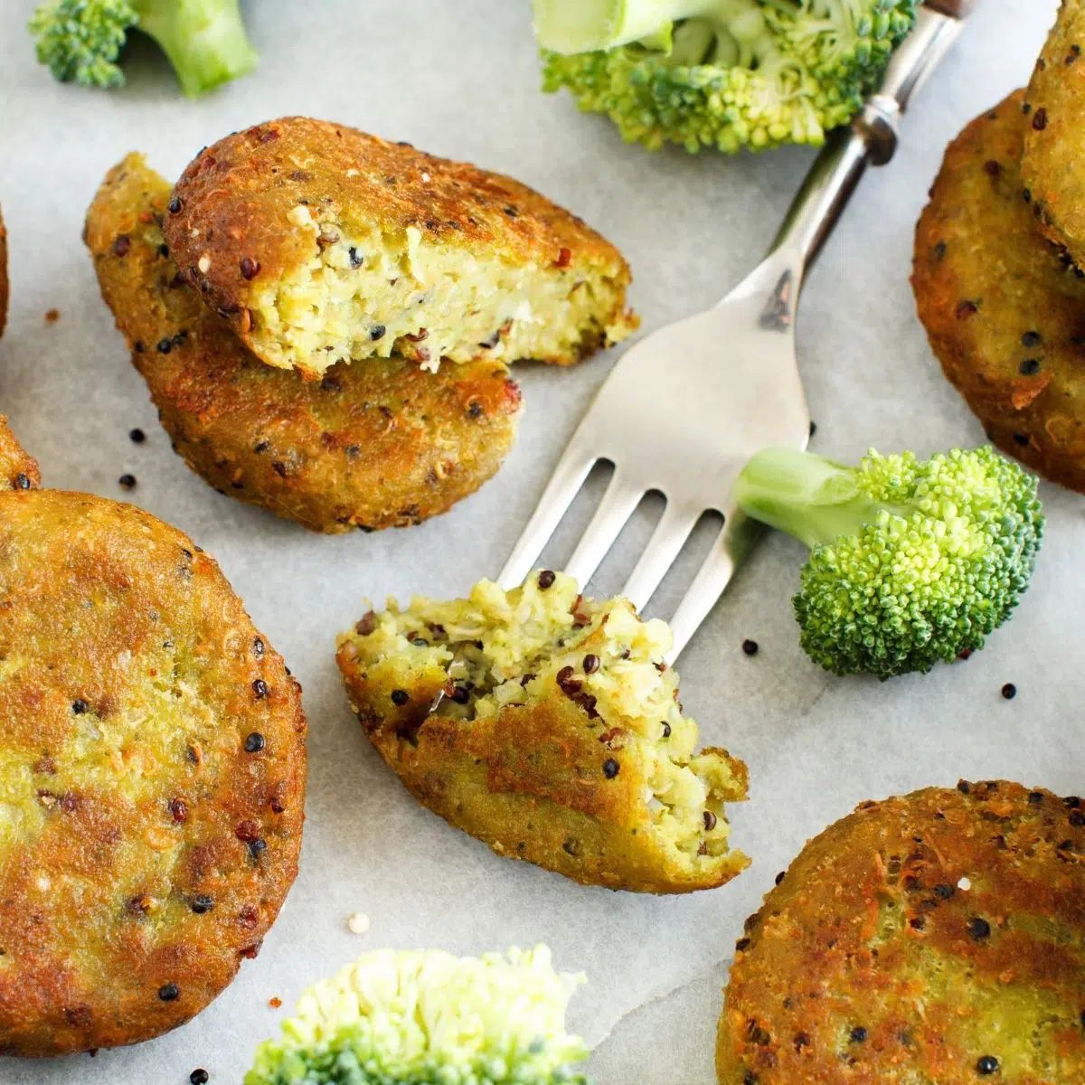 broccoli quinoa protein cakes on parchment paper