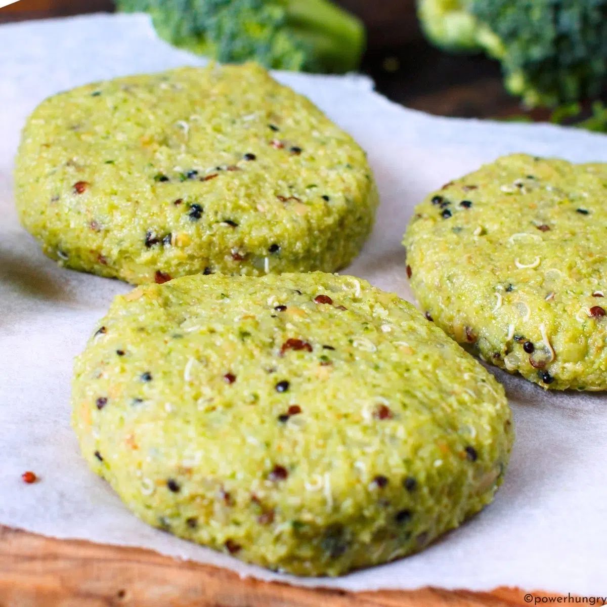 unbaked broccoli quinoa cakes on a cutting board