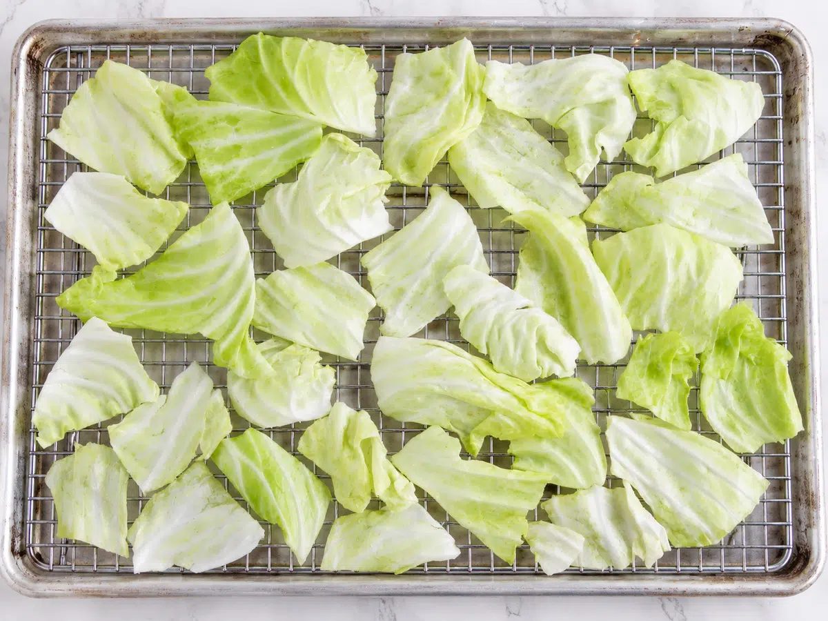 crispy cabbage chips laid out on rack to be baked