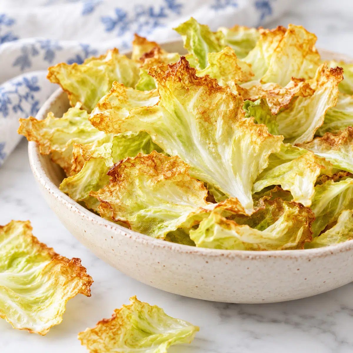 partial view of bowl of crispy baked cabbage chips