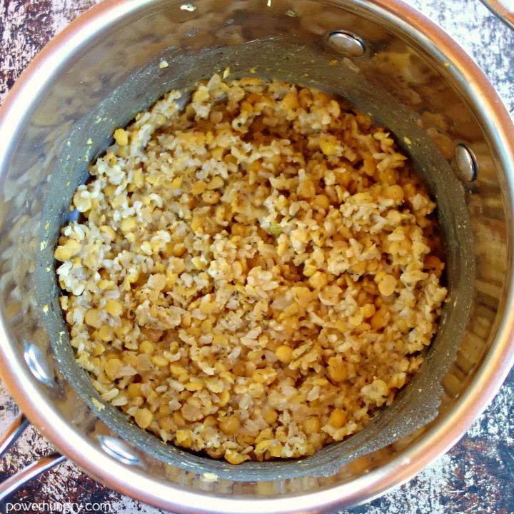 cooked brown rice and yellow split peas in a saucepan