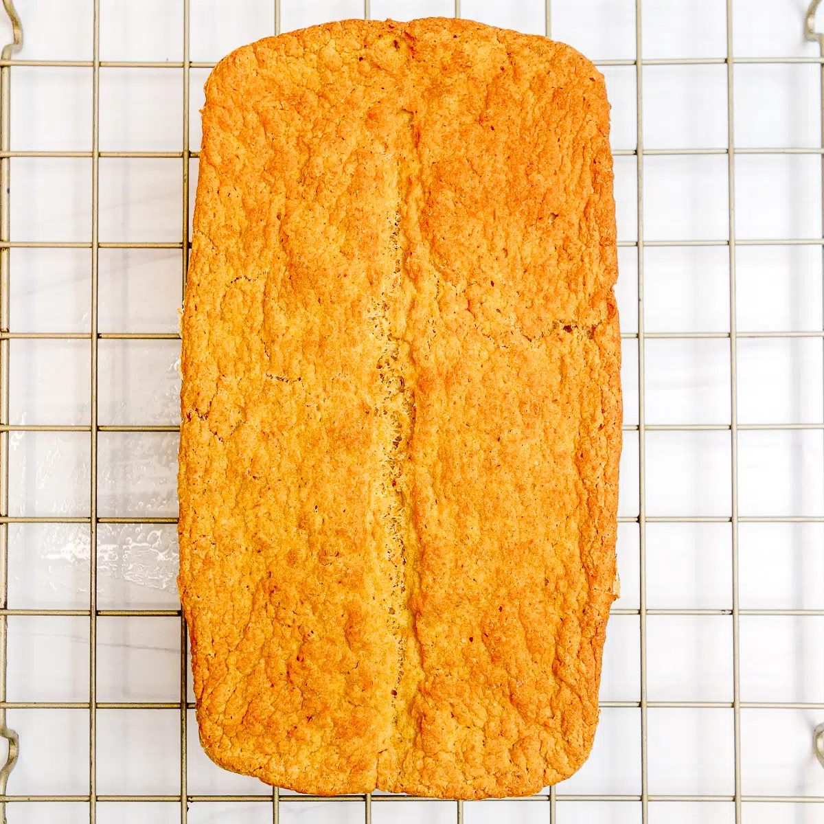 loaf of millet bean bread on cooling rack