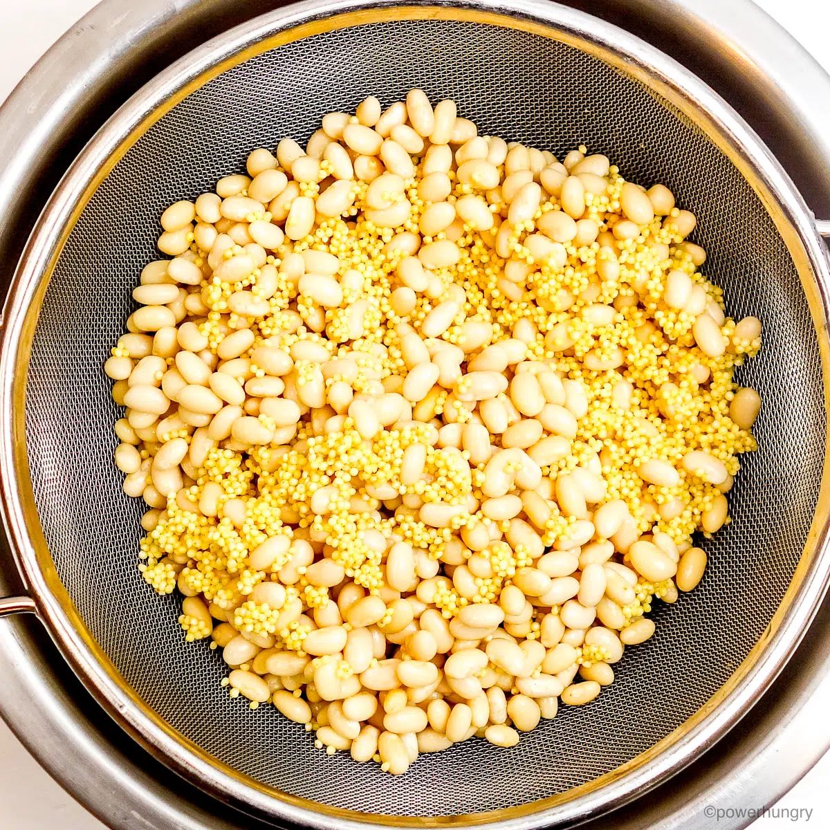 soaked millet and beans, draining in a mesh sieve