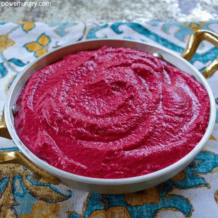 4-ingredient beet hummus in a decorative metal bowl , atop a colorful turquoise napkin