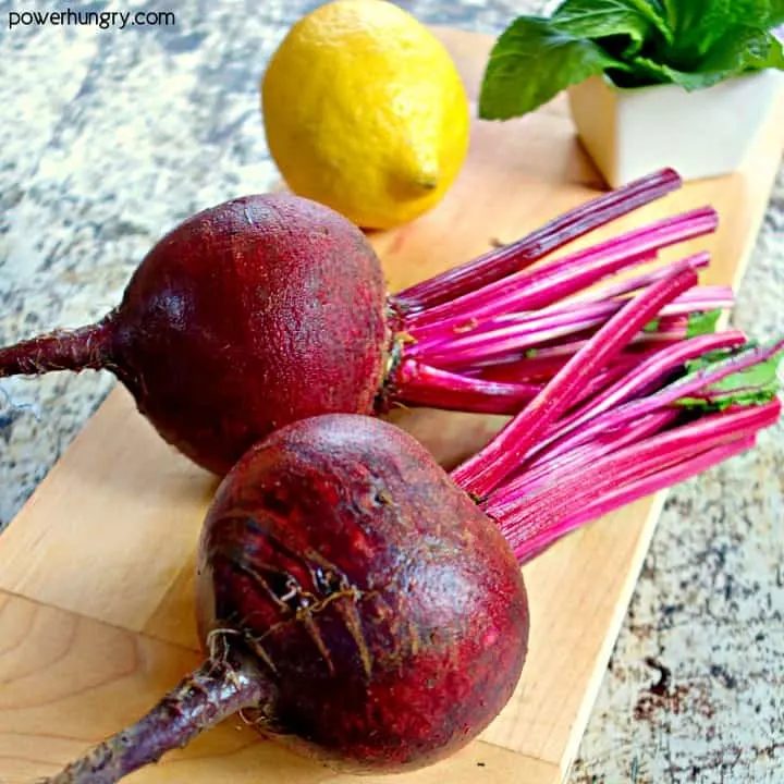 ingredients for fresh beet salad n a wooden cutting board
