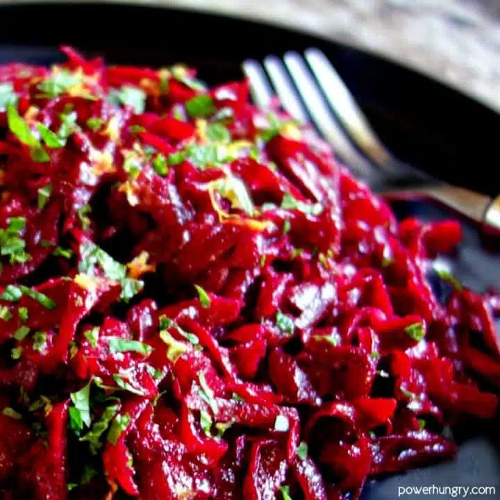 close-up of fresh beet salad with lemon & mint on a slate plate with a fork alongside