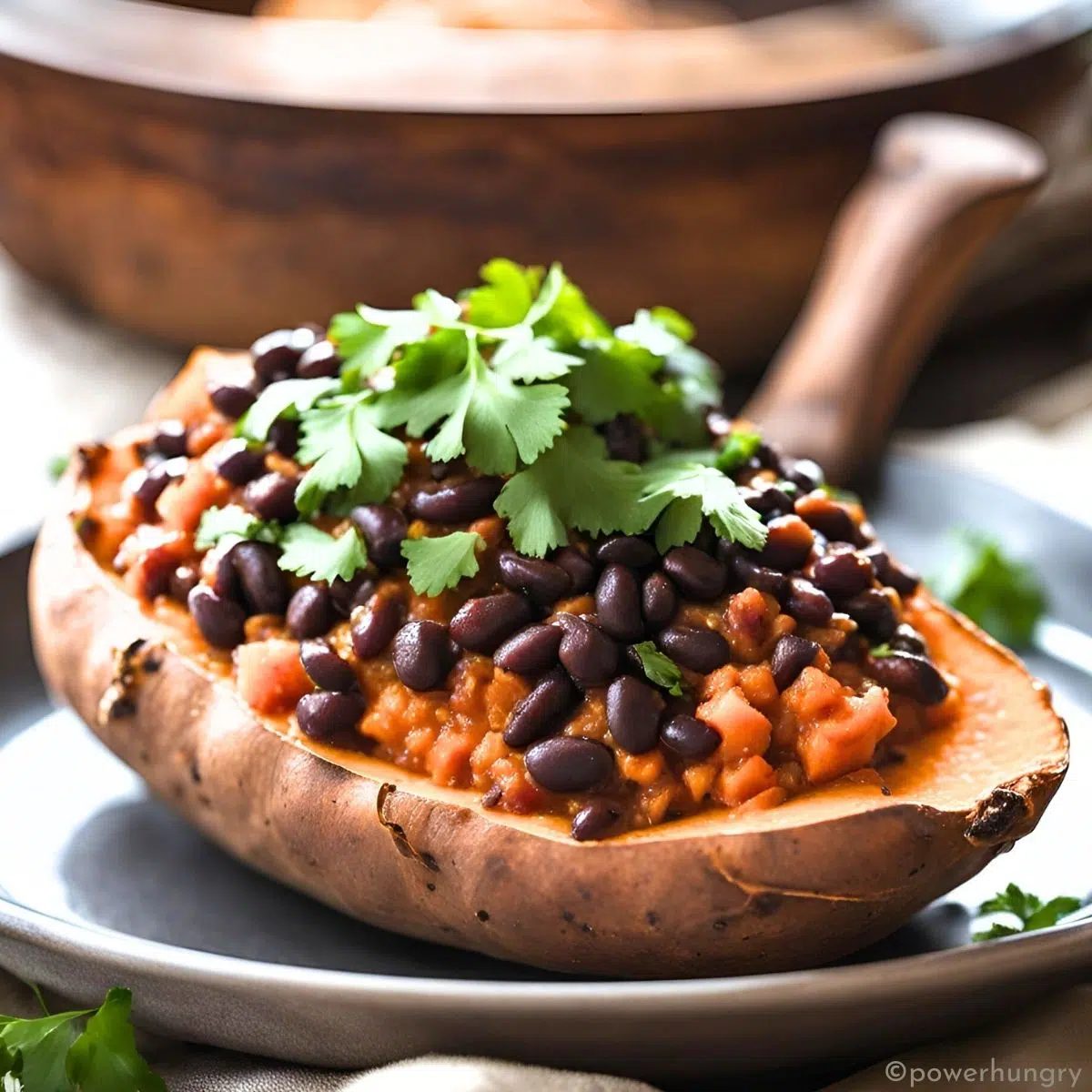 black bean chili stuffed sweet potto on a white plate