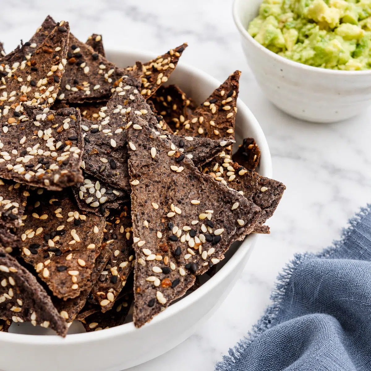 angled shot of black bean chips with guacamole