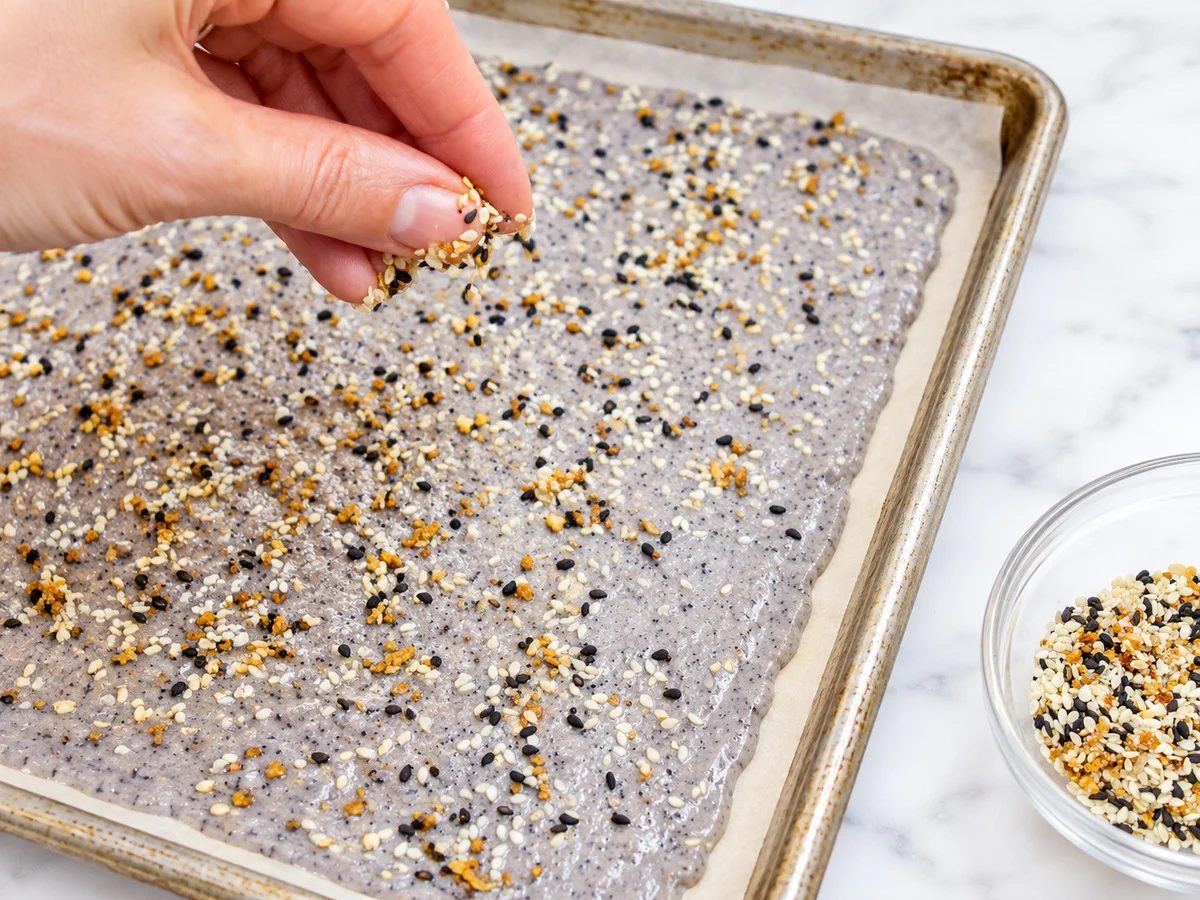 batter for black bean chips getting sprinkled with toppings