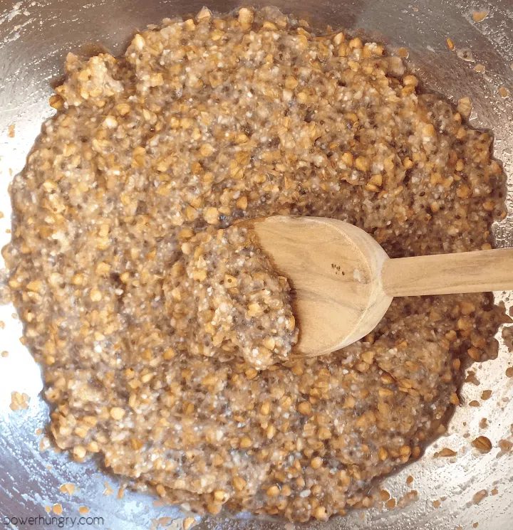 overhed shot of a stainless steel bowl filled with batter for buckwheat flax chia bread