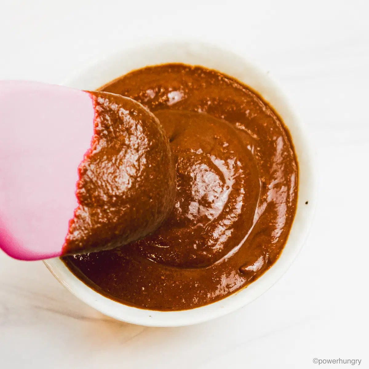 chocolate pudding getting spooned into a small bowl