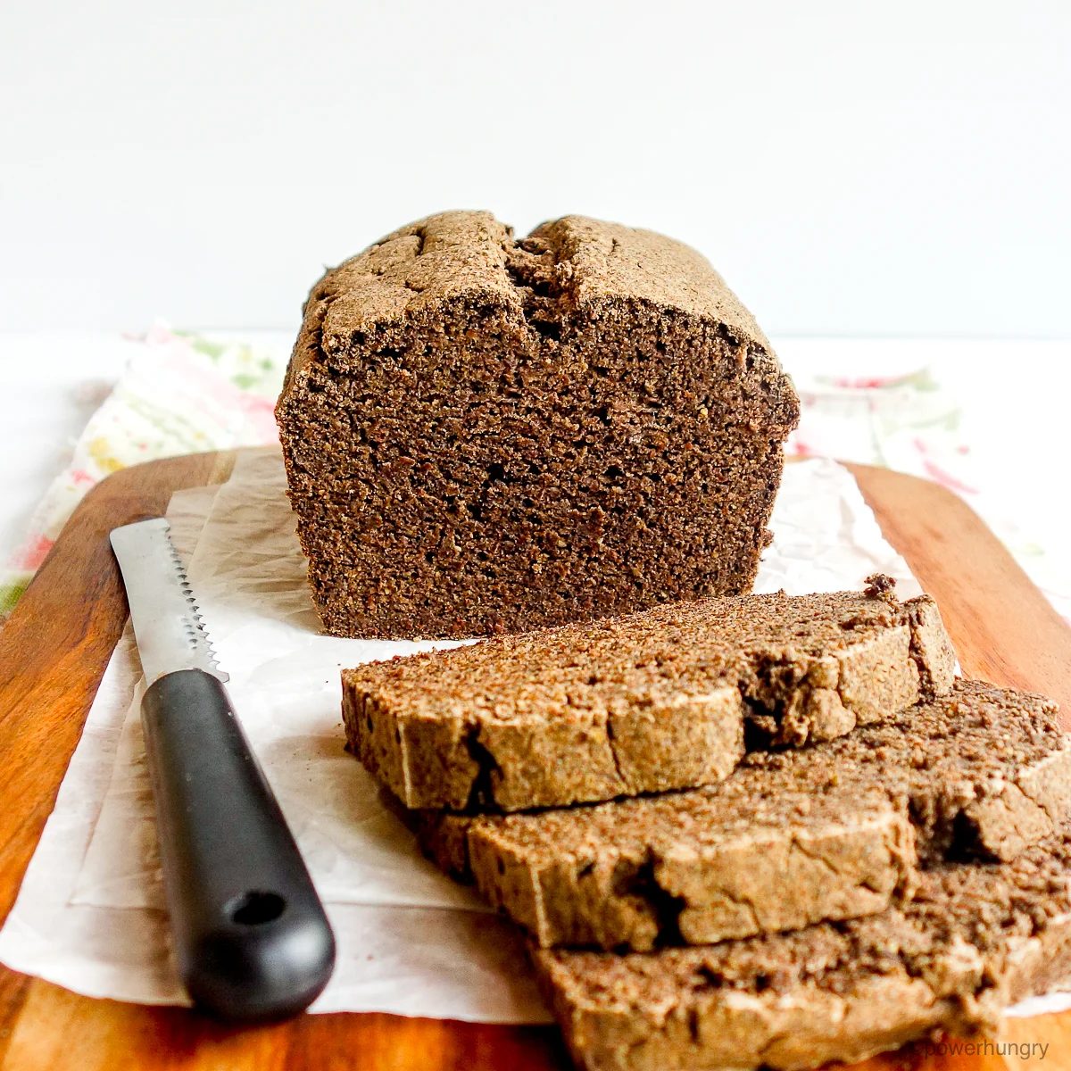 cutting board with a loaf of sliced buckwheat bread