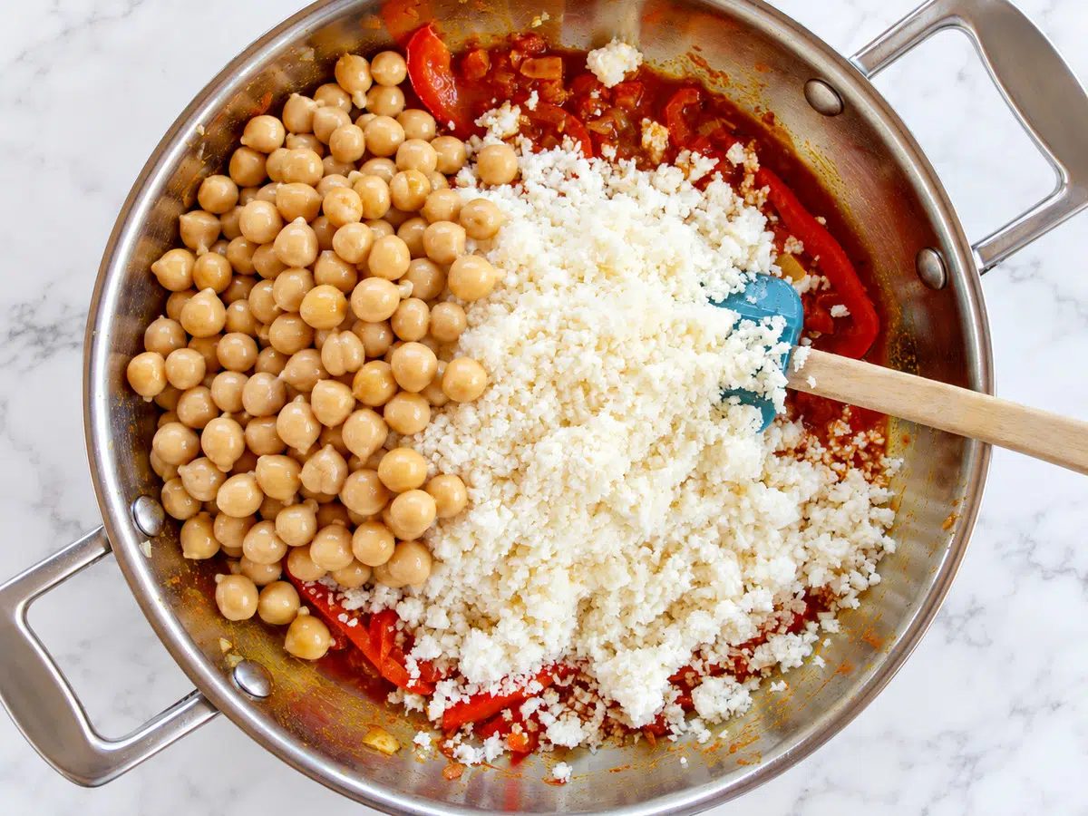 cauliflower rice and chickpeas added to the cauliflower paella