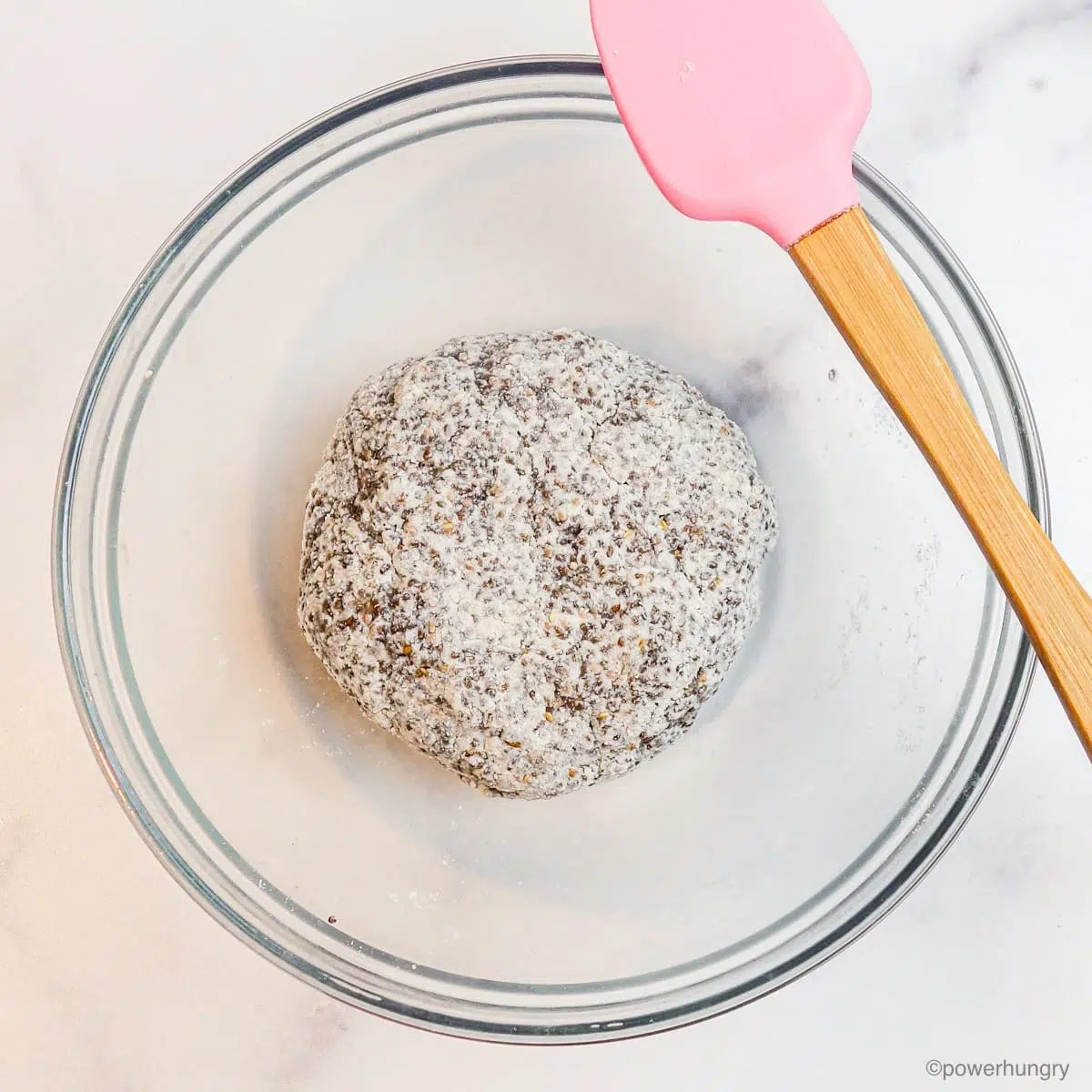 a ball of chia coconut flour tortilla dough in a glass bowl
