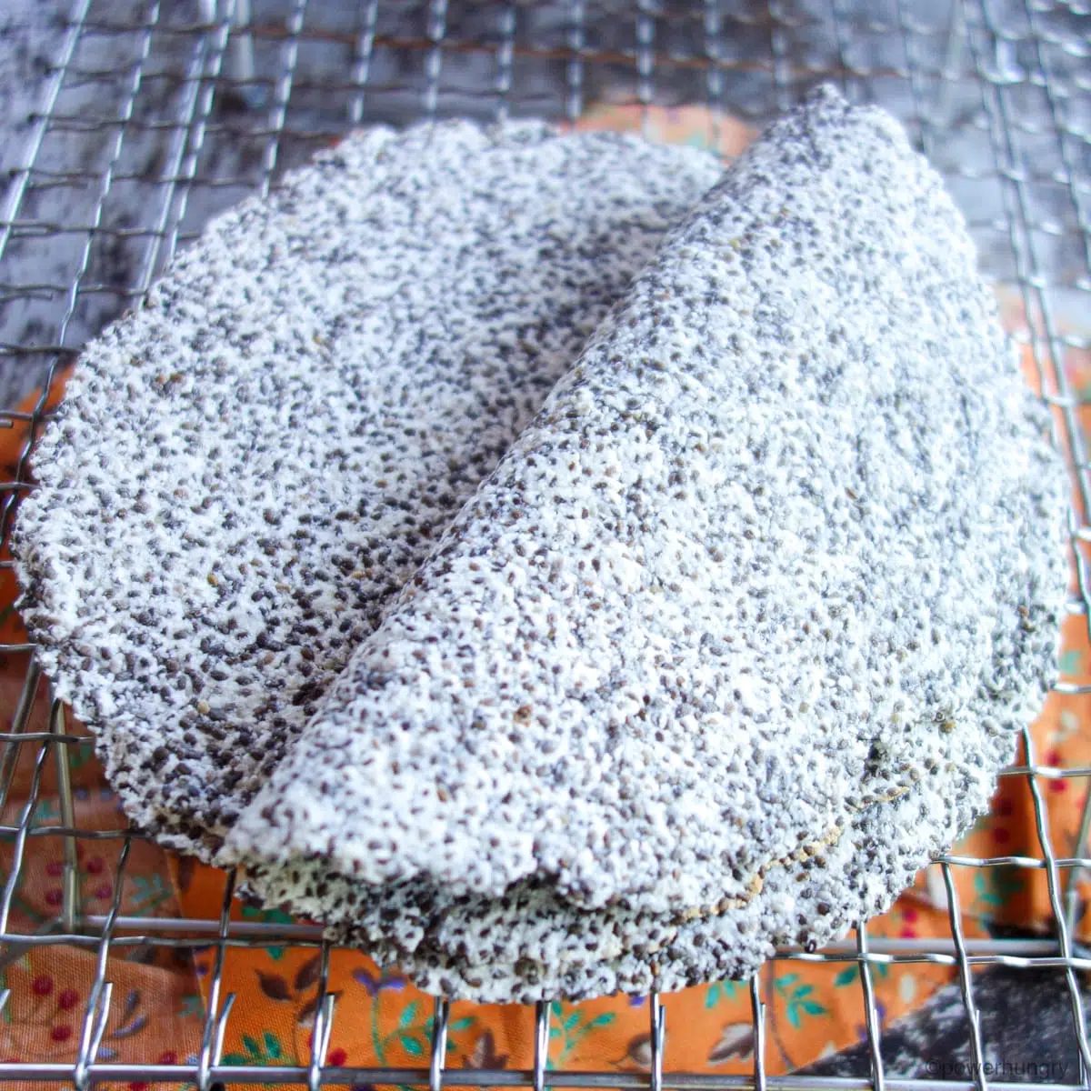 chia coconut flour tortillas in a stack with the top one folded