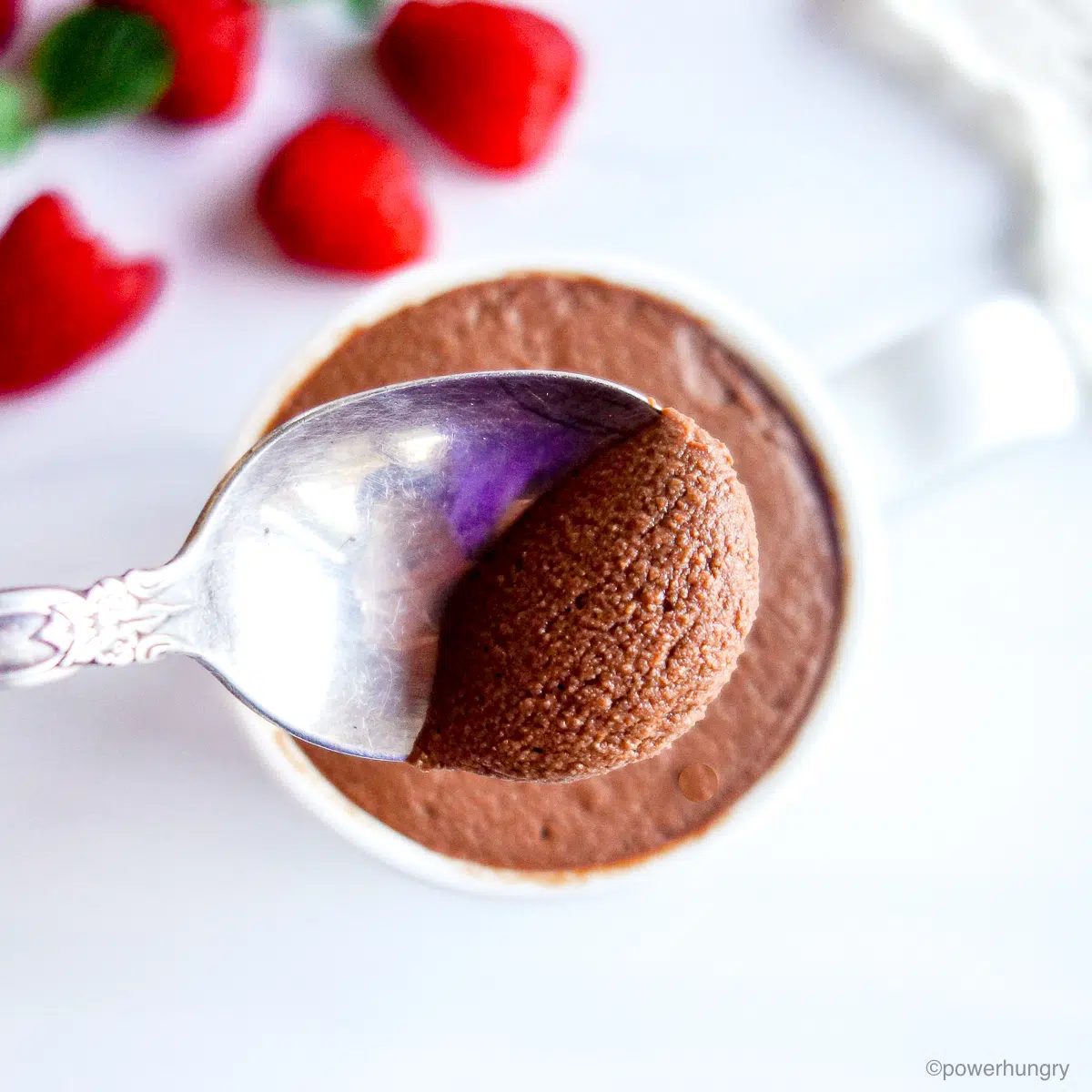overhead shot of chocolate protein mousse with a spoon