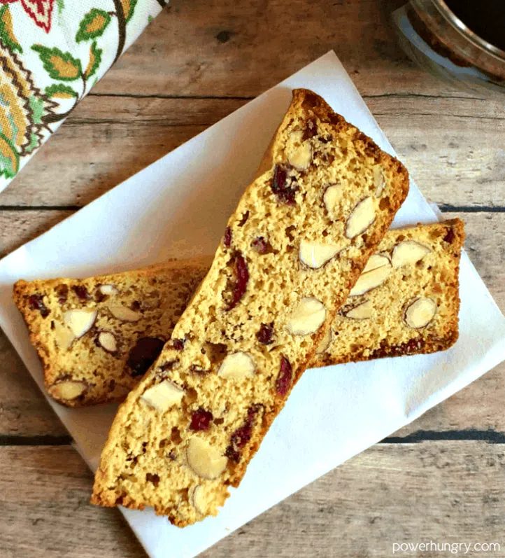 two vegan biscotti thins on a piece of white parchment paper.