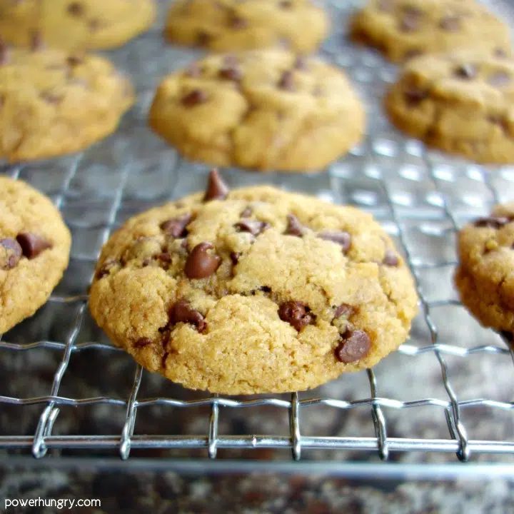 close up of a chocolate chip cookie on a wire cooling rack