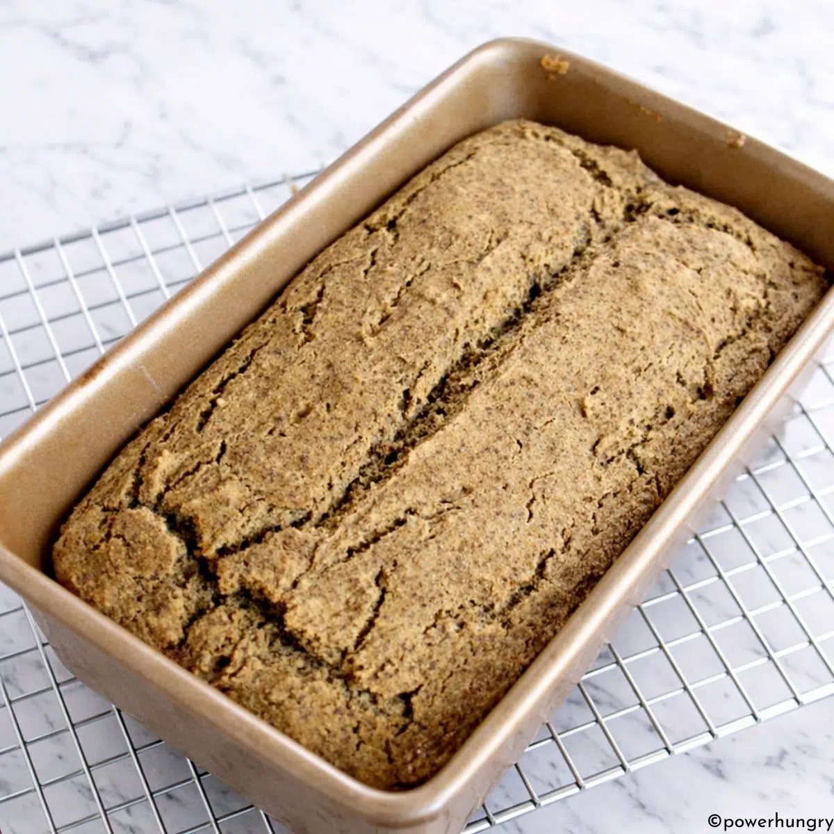 loaf of chickpea flour flax bread on cooling rack