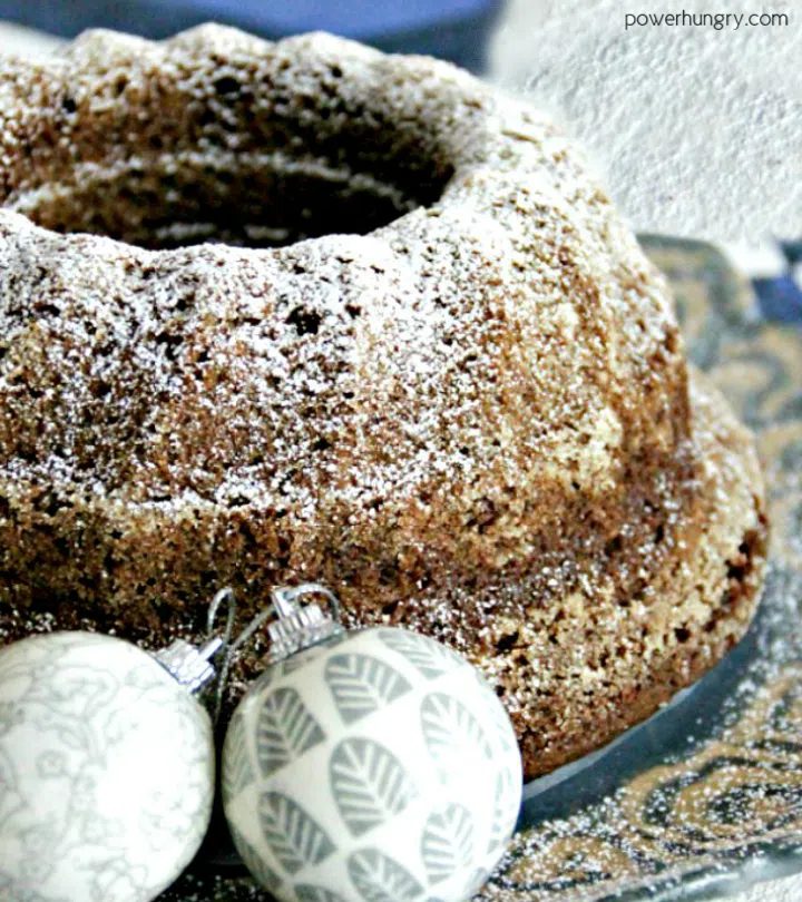chickpea flour gingerbread cake on a platter with Christmas ornaments
