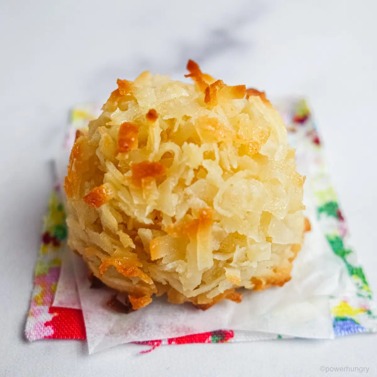 a single chickpea flour macaroon on a colorful napkin