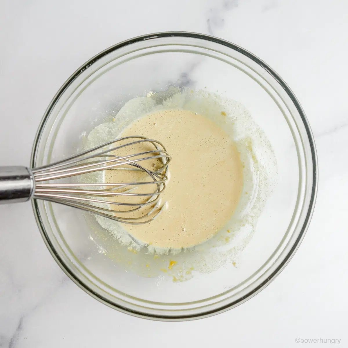 binding ingredients whisked in a glass bowl, for the vegan macaroons