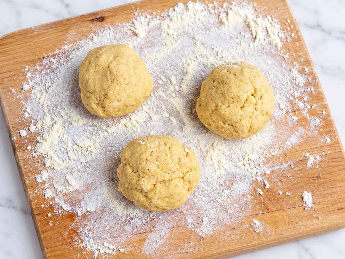 chickpea flour naan divided into three bals of dough
