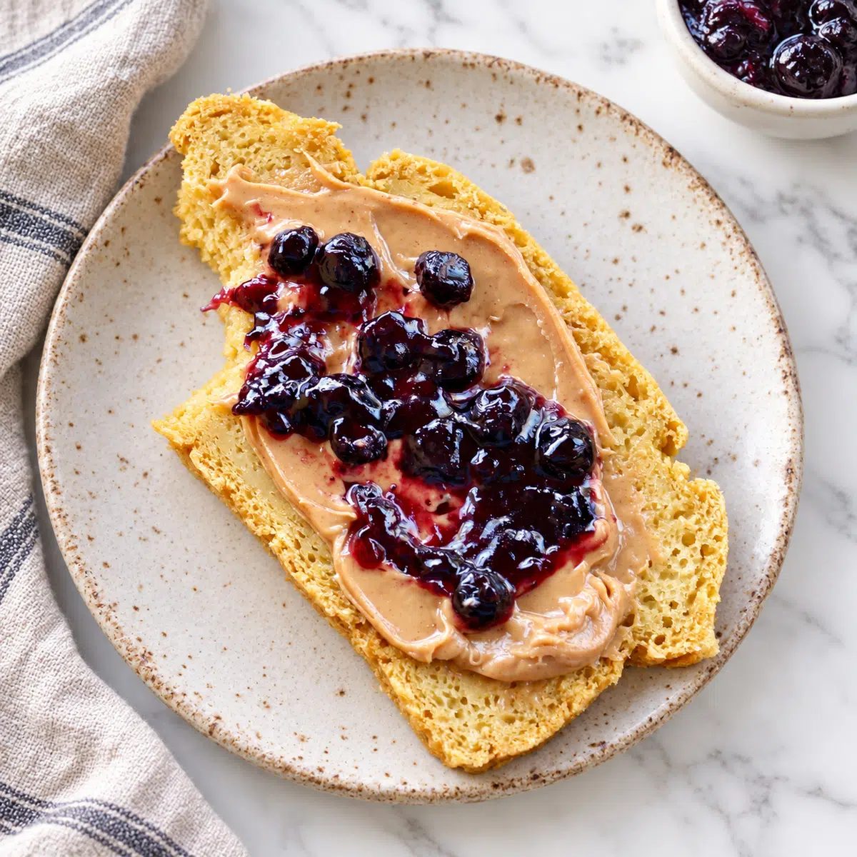 slice of chickpea flour bread with peanut butter and jam
