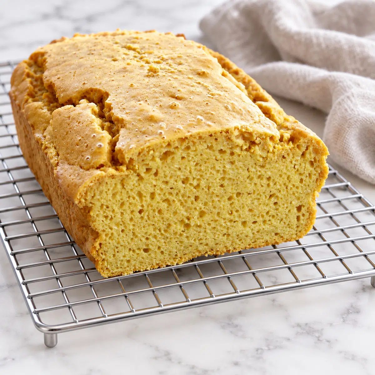 sliced loaf of chickpea flour bread, revealing interior of loaf