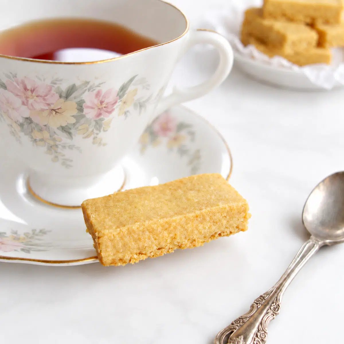 chickpea flour shortbread alongside a cup of tea