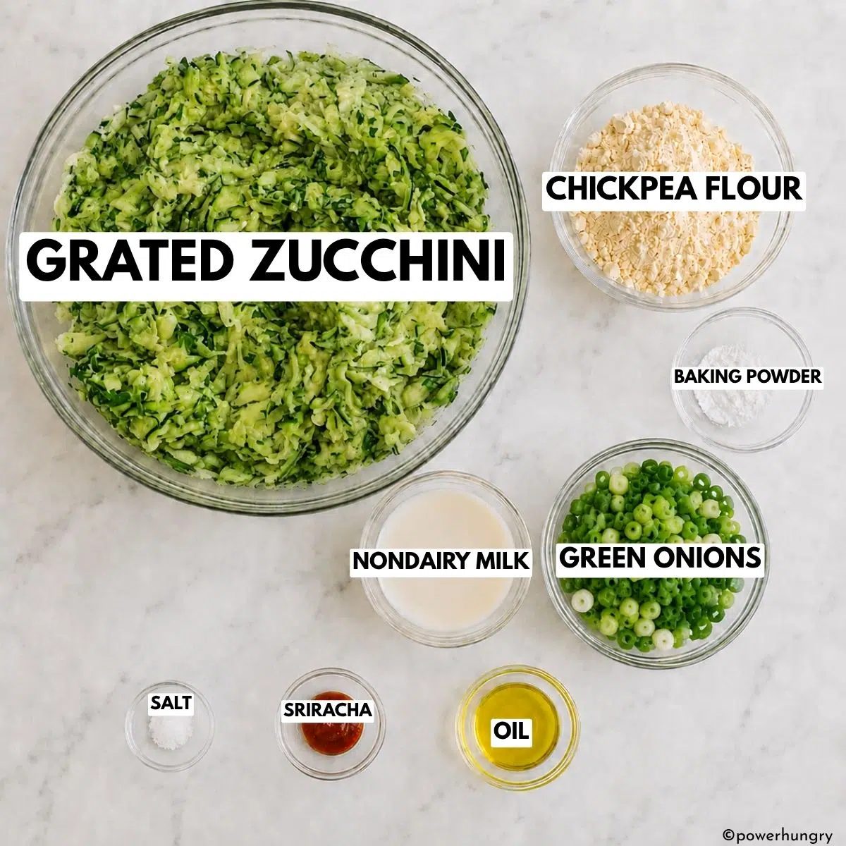 ingredients for the vegan zucchini chickpea flour fritters , all in glass prep bowls