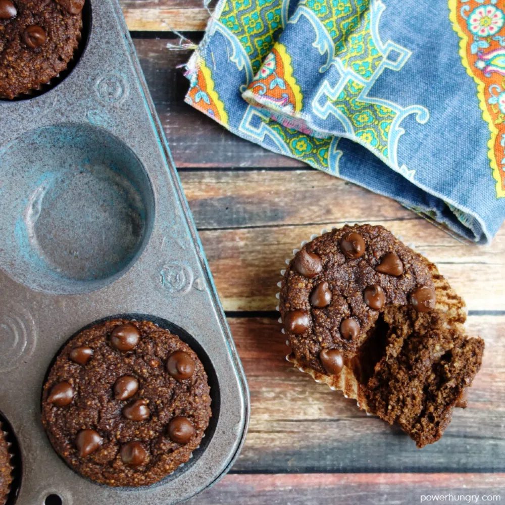 overhead shot of chocolate muffins, with one outside of the muffin tin