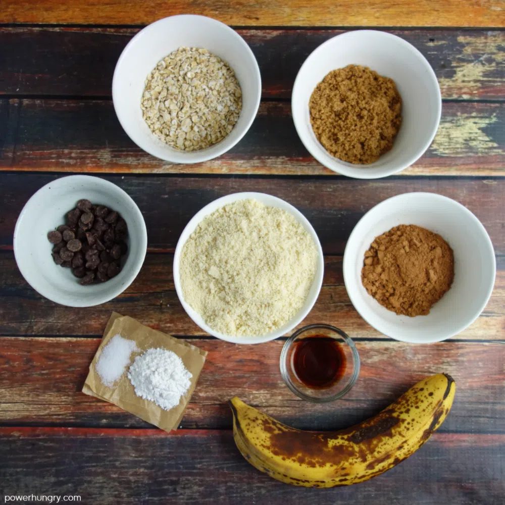 ingredients for nourishing chocolate muffins laid out on a wooden background