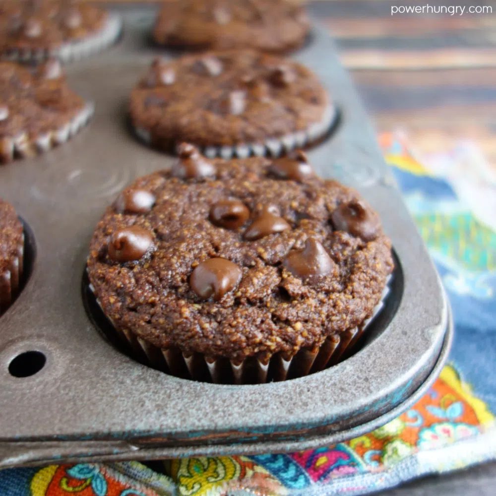 close up of a chocolate almond flour oat muffin in an antique muffin tin