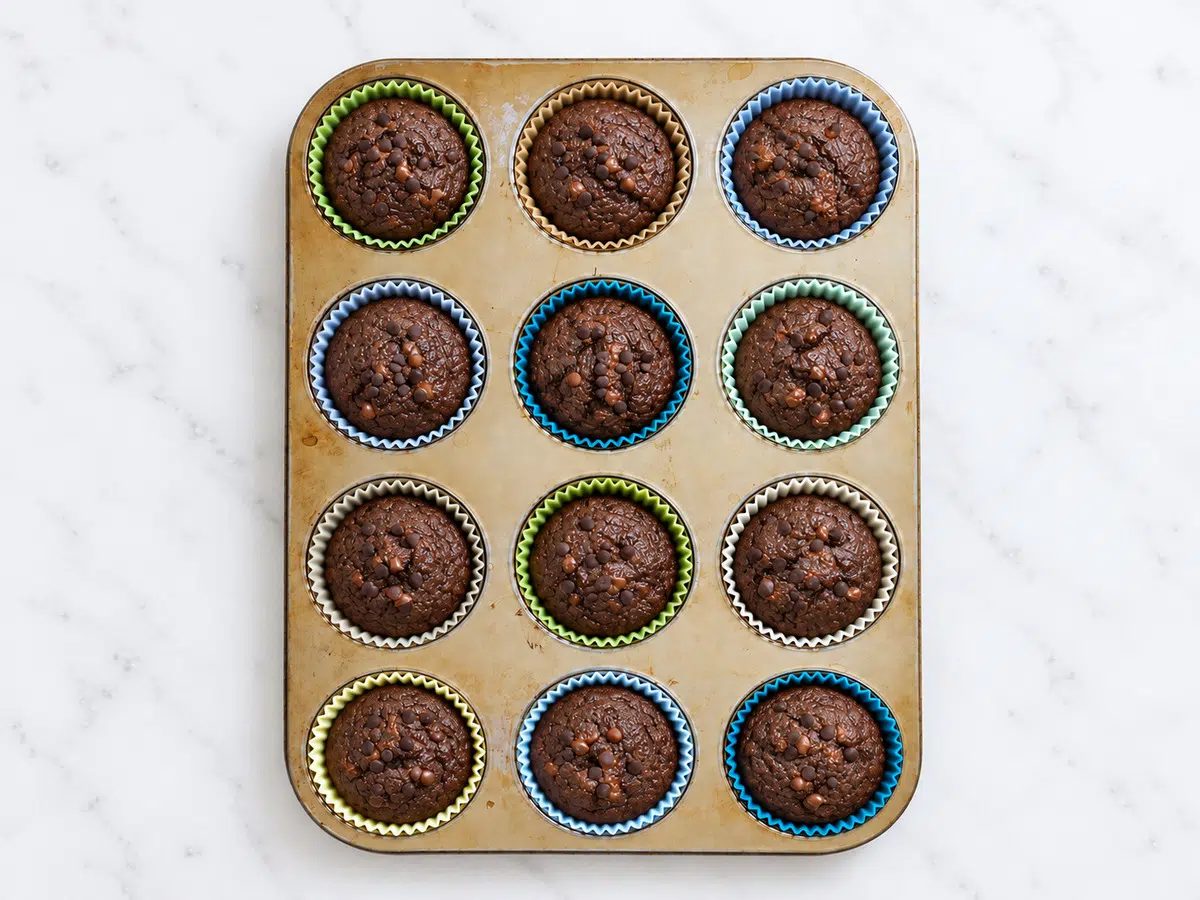 fresh baked vegan chocolate buckwheat muffins still in the muffin tin