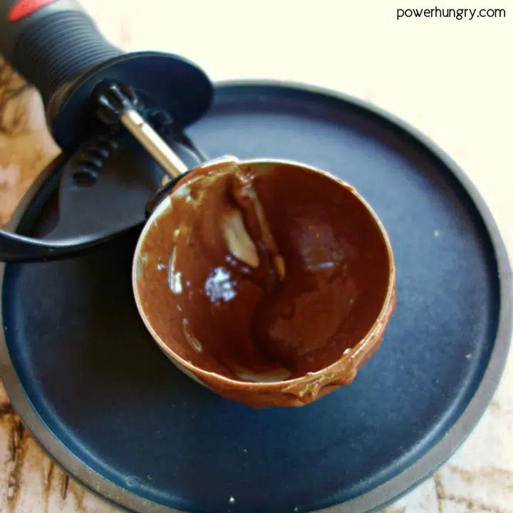 Batter or ice cream scoop filled with muffin batter