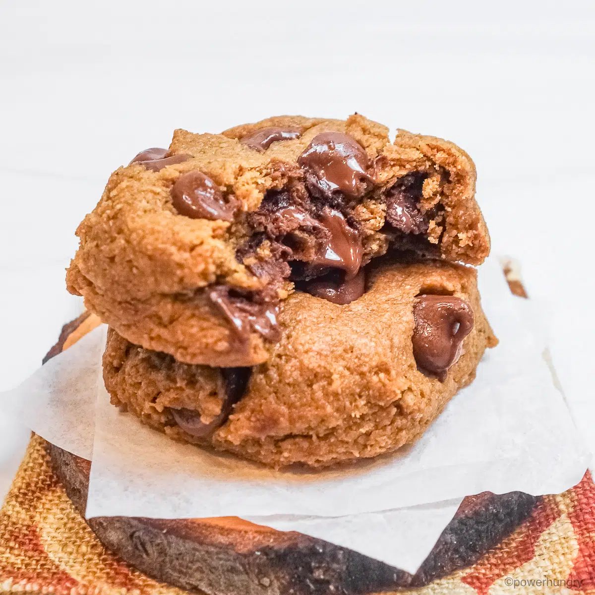 two chocolate chip flax cookies, one with a bite out of it