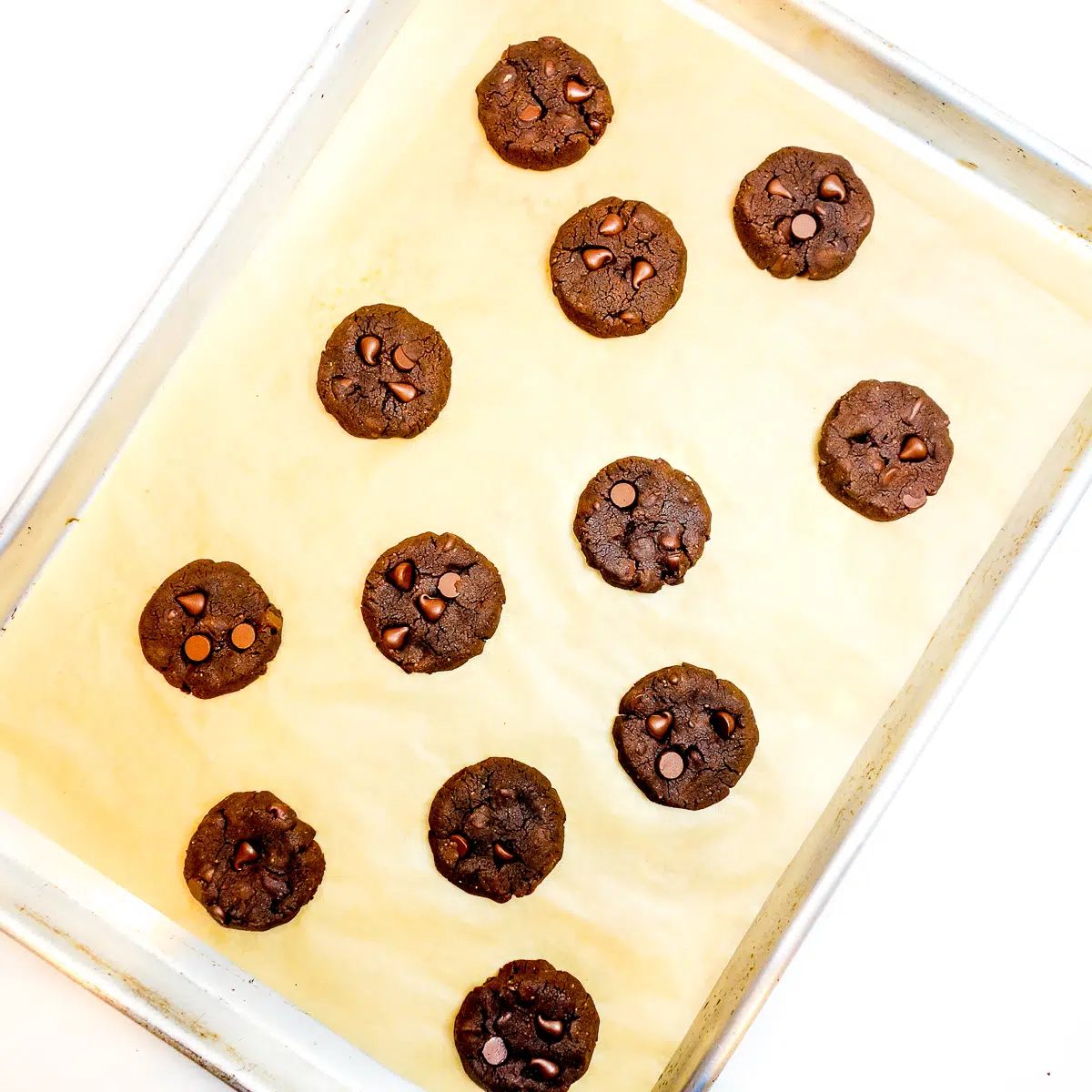 baked chickpea flour chocolate peanut butter cookies on a baking sheet