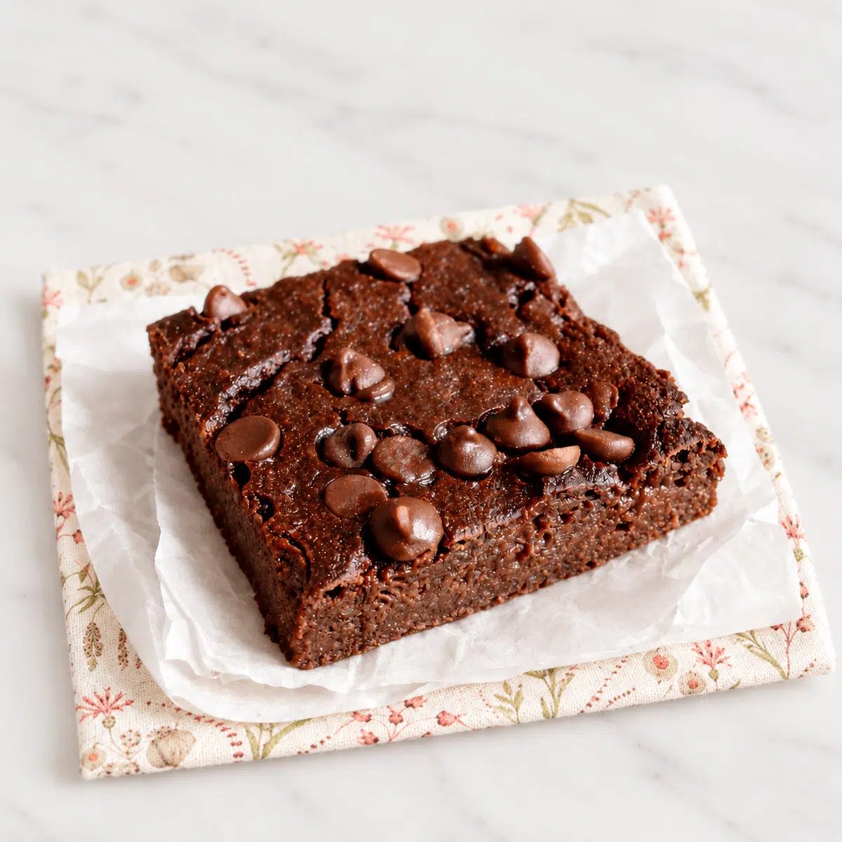 single vegan low calorie brownie on a floral napkin