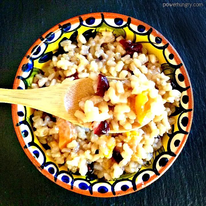 close up of a wooden spoon full of coconut brown rice pudding